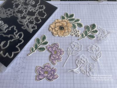 Cut outs of designs after coloring them to be placed on a greeting card